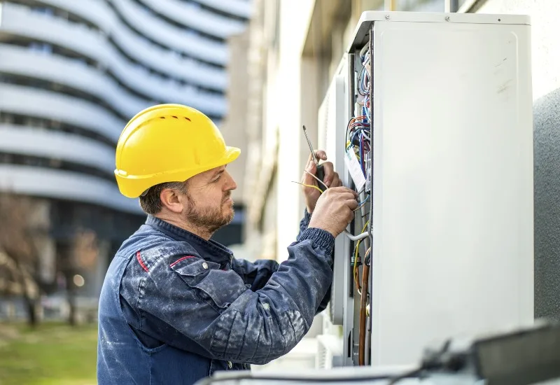 AC Technician Working On Outdoor Unit