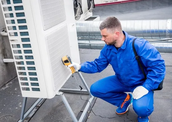 HVAC Technician Checking An Outdoor Unit With A Diagnostic Tool