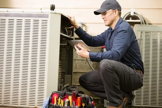 Pure Climate Heating And Cooling Expert Examining HVAC Unit