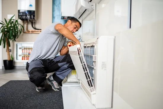 Pure Climate Heating And Cooling Expert Fixing A Air Conditioner<br />
