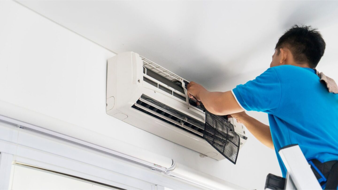 Technician Servicing Air Conditioner